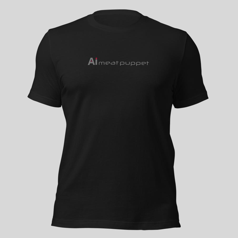The front of a black AI Meat Puppet T-shirt with the AI Meat Puppet logo on it against a light grey background